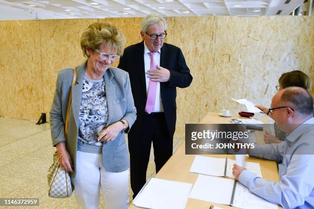 Jean-Claude Juncker , head of the European Commission and his wife Christiane Frising arrive to vote at a polling station in Capellen, on May 26 as...