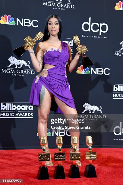 Cardi B poses with the awards for Top Rap Song 'I Like It,' Top Hot 100 Song for 'Girls Like You,' in the press room during the 2019 Billboard Music...