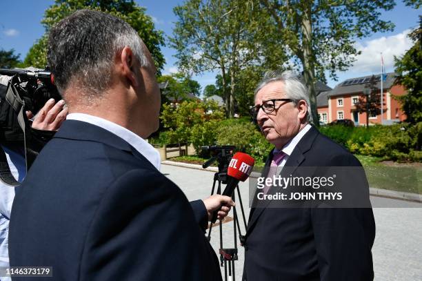 Jean-Claude Juncker, head of the European Commission speaks to the press outside a polling station in Capellen, on May 26 after a vote as part of the...