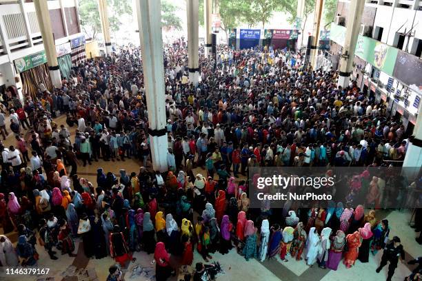 Bangladeshi travelers queue to collect tickets at the Kamalapur railway station in Dhaka, on May 26 as Bangladesh Railways starts selling advance...