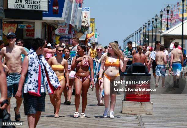 People walk along the boardwalk during Memorial Day weekend on May 26, 2019 in Seaside Heights , New Jersey. Memorial Day is the unofficial start of...