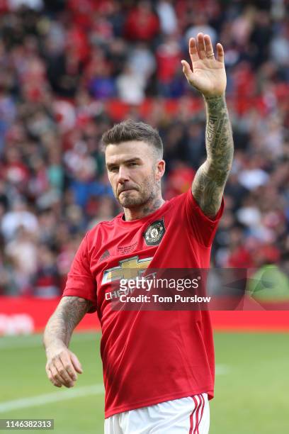 David Beckham of Manchester United '99 Legends acknowledges the fans at the end of the 20 Years Treble Reunion match between Manchester United '99...