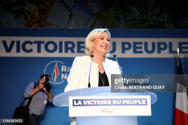 French far-right Rassemblement National President and member of Parliament Marine Le Pen delivers a speech after the announcement of initial results...