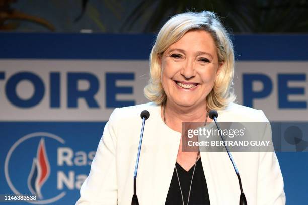 French far-right Rassemblement National President and member of Parliament Marine Le Pen delivers a speech after the announcement of initial results...