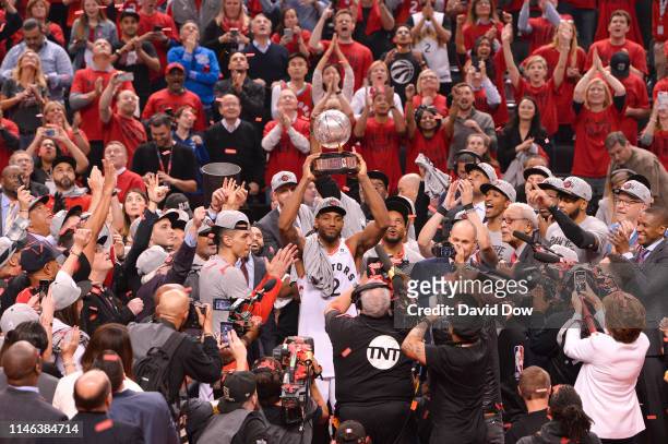 Kawhi Leonard of the Toronto Raptors holds up the Eastern Conference Championship trophy after a game against the Milwaukee Bucks after Game Six of...