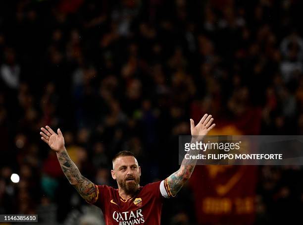 Roma's Italian midfielder Daniele De Rossi is acknowledged by fans during his farewell to Roma after 18 years at his home-town club at the end of the...