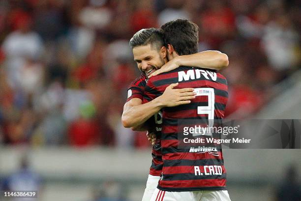 Rodrigo Caio of Flamengo celebrates with his teammate Diego Ribas after scoring the third goal of his team during a match between Flamengo and...