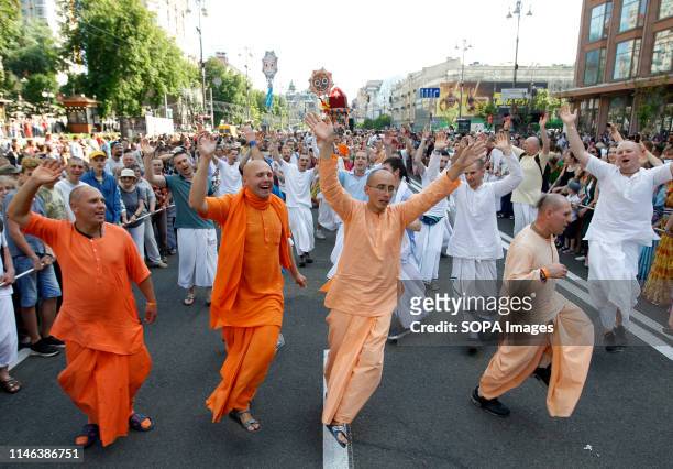 Hare Krishna devotees are seen dancing while pulling a decorative chariot eight meters high during the Ratha-Yatra Carnival of Chariots in Kiev....