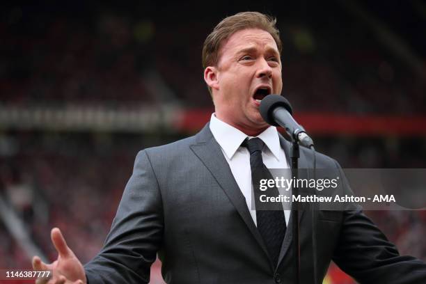 Singer Russell Watson entertains the crowd prior to the Manchester United '99 Legends v FC Bayern Legends match at Old Trafford on May 26, 2019 in...