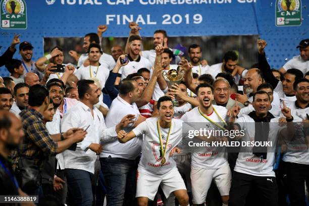 Egypt's Zamalek players celebrate with the trophy after they won the CAF Confederation Cup final football match between Egypt's Zamalek and Morocco's...