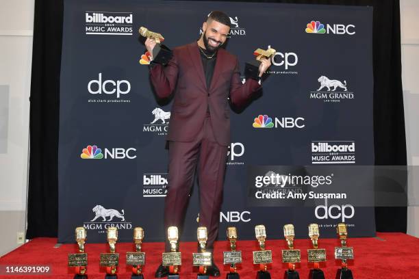 Drake poses with the awards for Top Artist, Top Male Artist, Top Billboard 200 Album for “Scorpion”, Top Billboard 200 Artist, Top Hot 100 Artist,...