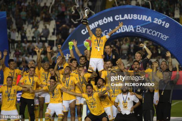 Tigres' players celebrate with the trophy after winning the final match against Leon and the Mexican Clausura tournament 2019 at the Leon stadium on...