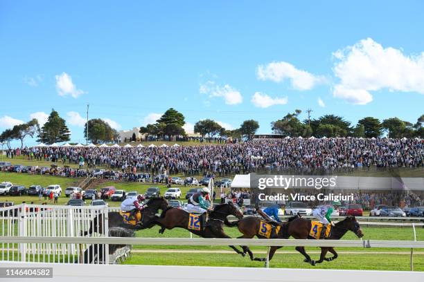 General view racegoers watching from the hill as horses and riders on the first lap of the 5550 meter Race 7 Waterfront by Lyndoch Living Grand...