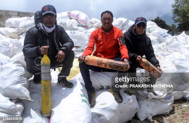 Nepali climbers pose for photographs after collecting waste from the Mount Everest at Namche Bazar, on May 27 before it is transported to Kathmandu...