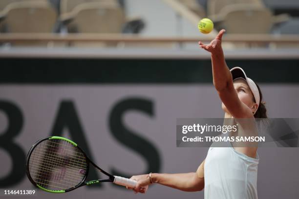 Russia's Veronika Kudermetova serves the ball to Denmark's Caroline Wozniacki during their women's singles first round match on day two of The Roland...