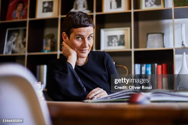 portrait of smiling short-haired woman at home - 45 year old woman stock pictures, royalty-free photos & images