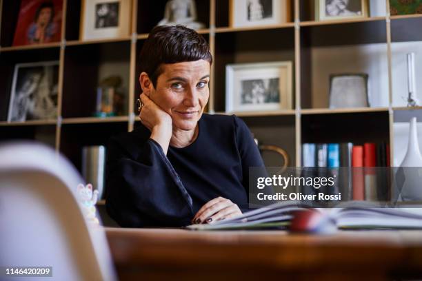 portrait of smiling short-haired woman at home - wisdom stock pictures, royalty-free photos & images
