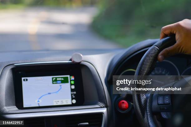 gps and car steering wheel - hand steering wheel stock pictures, royalty-free photos & images