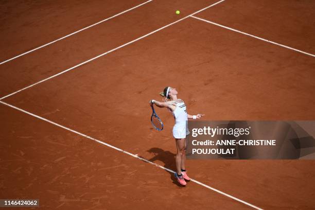 France's Pauline Parmentier serves the ball to Netherlands' Kiki Bertens during their women's singles first round match on day two of The Roland...