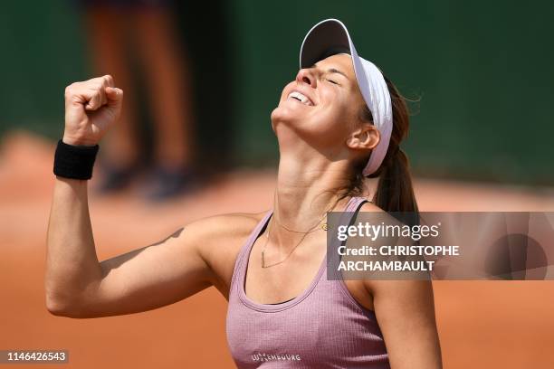 Luxembourg's Mandy Minella celebrates after winning against Russia's Anastasia Pavlyuchenkova during their women's singles first round match on day...
