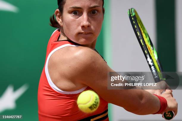 Latvia's Anastasija Sevastova eyes the ball as she plays a backhand return to Thailand's Luksika Kumkhun during their women's singles first round...