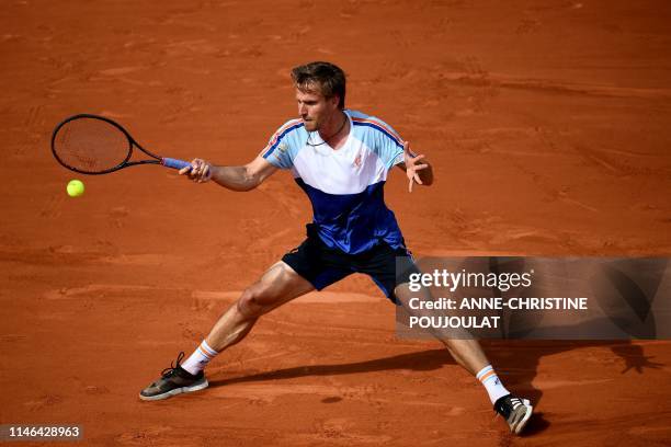 Germany's Peter Gojowczyk returns the ball to France's Jo-Wilfried Tsonga during their men's singles first round match on day two of The Roland...