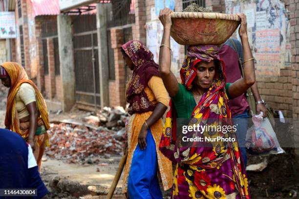 Bangladeshi women daily labor works in a road construction side in Dhaka, Bangladesh, on May 27, 2019. Each woman labor earns 500 taka or 6 US Dollar...