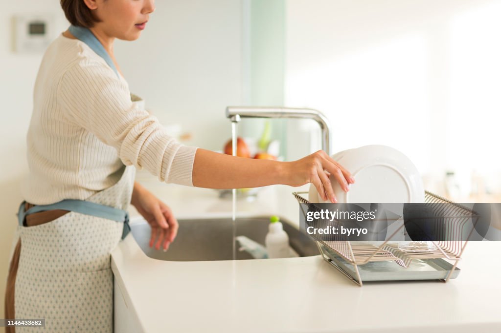Housewife washing dishes