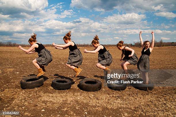 tire jumping - multiple images of the same person stock pictures, royalty-free photos & images