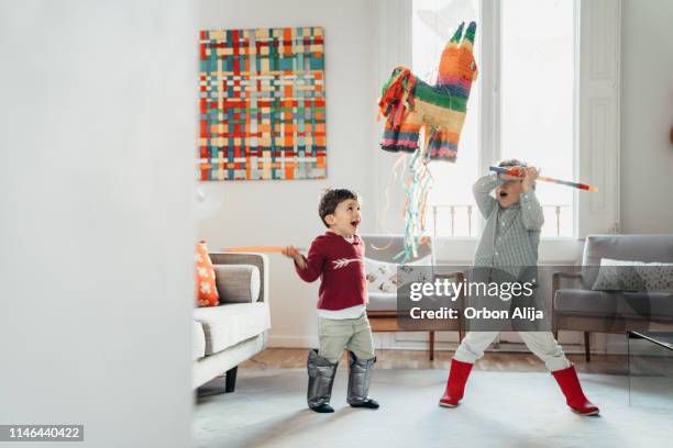 boys breaking piñata at a party - papier stock pictures, royalty-free photos & images