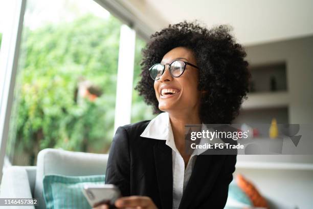 busniness woman smiling and looking away - african ethnicity finance stock pictures, royalty-free photos & images