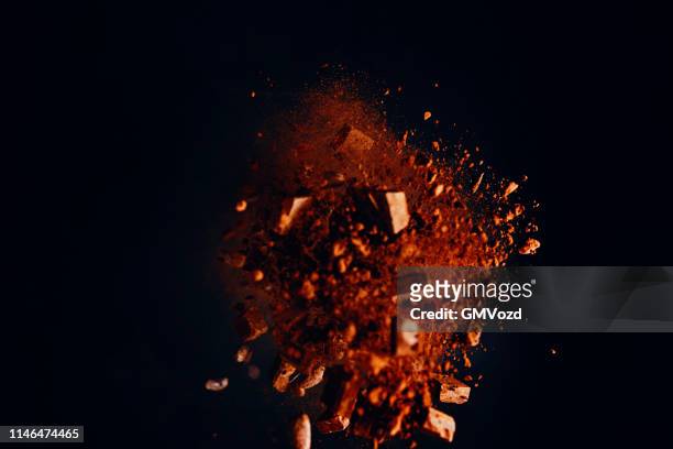 chocolate food explosion with cocoa powder and chocolate chips - chocolate explosion stock pictures, royalty-free photos & images
