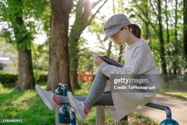 girl writing on digital tablet with stylus pen - e learning draw stock pictures, royalty-free photos & images