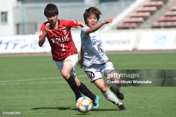 Kana Osafune of Urawa Red Diamonds Ladies and Mana Iwabuchi of INAC Kobe compete for the ball during the Nadeshiko League Division 1 match between...