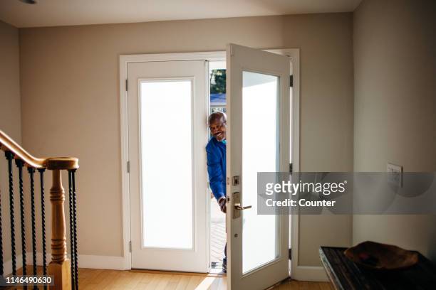 mature man at front door of his house - arriving home stockfoto's en -beelden