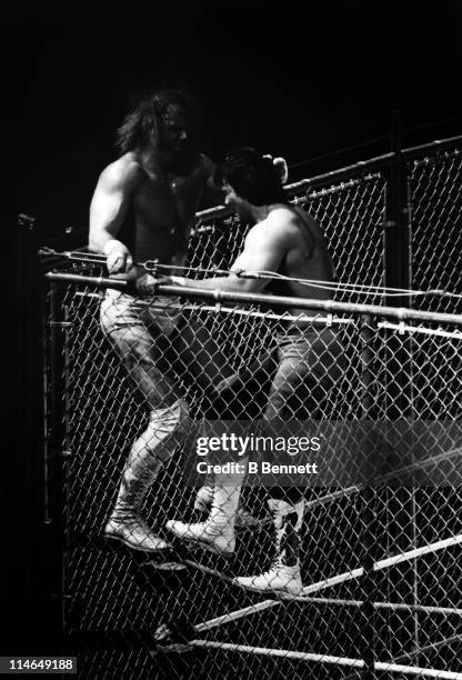 Ricky "The Dragon" Steamboat wrestles with Randy "Macho Man" Savage on the top turn buckle during their WWF steel cage match circa 1987.