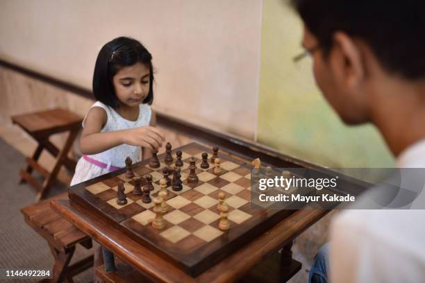 brother and sister playing chess - snakes and ladders stock pictures, royalty-free photos & images