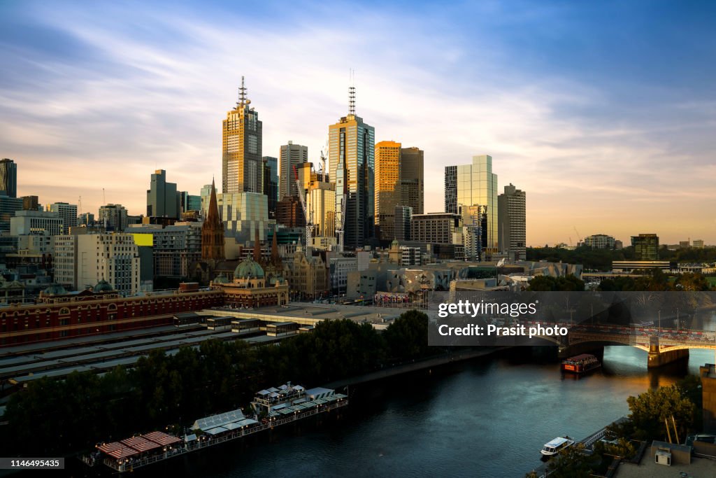 Sunset over city skyline of Melbourne downtown, Princess Bridge and Yarra River in Melbourne, Victoria, Australia.