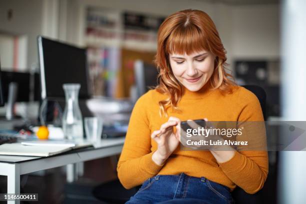 businessman using her mobile phone in office - person on mobile phone imagens e fotografias de stock