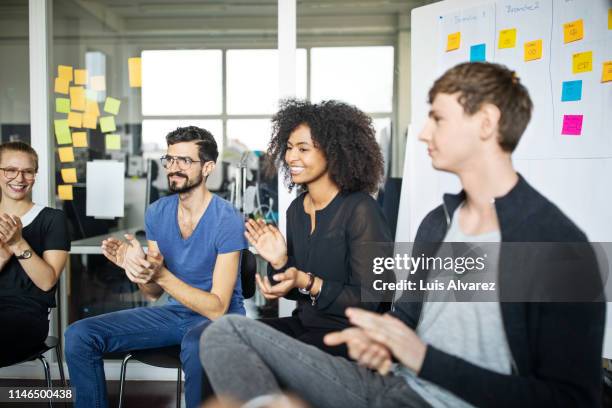 multi-ethnic business group clapping hands - germany team presentation stockfoto's en -beelden