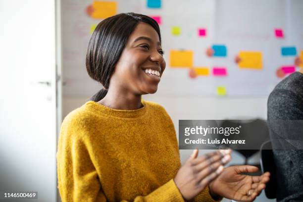 woman applauding after productive meeting - motivation stock-fotos und bilder