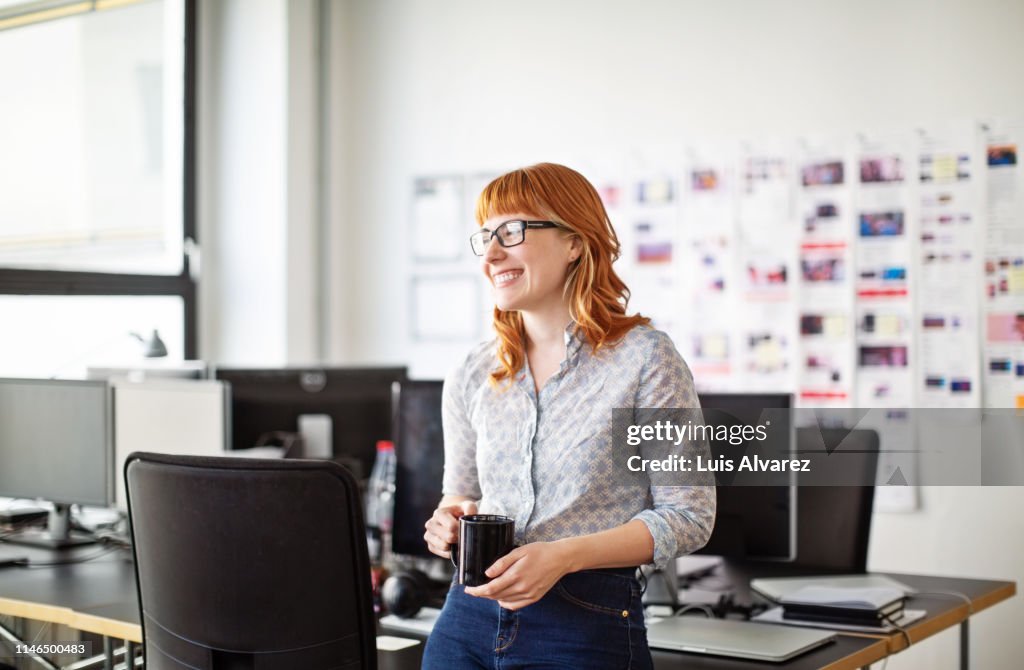 Businesswoman having a coffee break in office