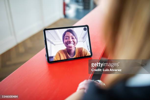 Two women colleagues on video chat in office