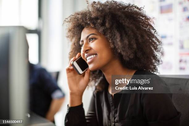 businesswoman using cell phone at her desk - african on phone stock pictures, royalty-free photos & images