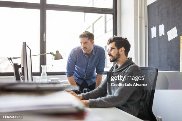business professionals working together on a computer - computer programmer stock-fotos und bilder