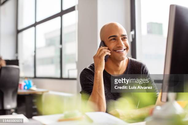 male professional working at his office desk - happy customer stock pictures, royalty-free photos & images