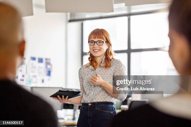 businesswoman sharing her views with team - man fringe stock pictures, royalty-free photos & images