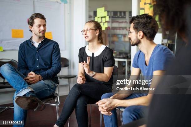 woman discussing new strategies with team - workshop participant stock pictures, royalty-free photos & images