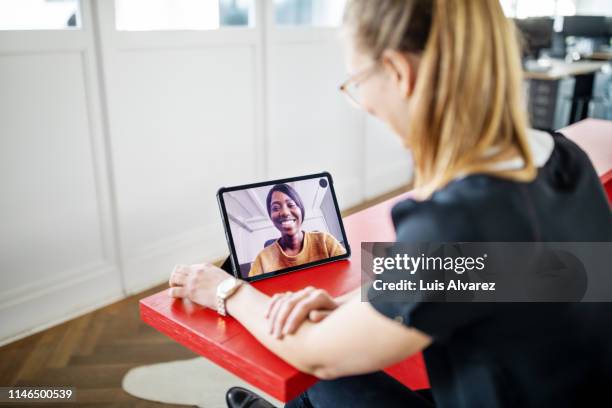 female executives having video call in office - two people video conferencing stock pictures, royalty-free photos & images