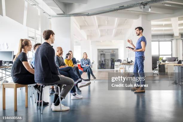 man discussing new ideas with team - germany team presentation stockfoto's en -beelden